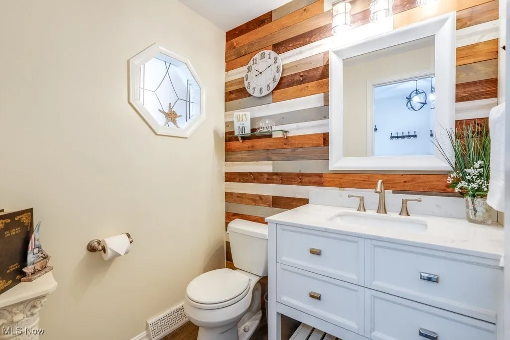 Bathroom with vanity and wooden walls