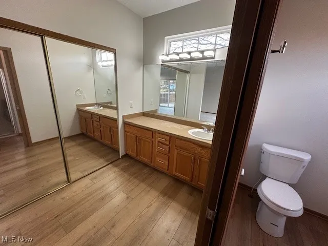 Full bathroom with vanity and light wood-type flooring