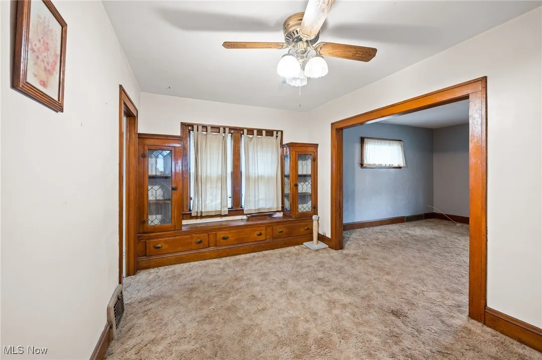 Dining room with light colored carpet and ceiling fan