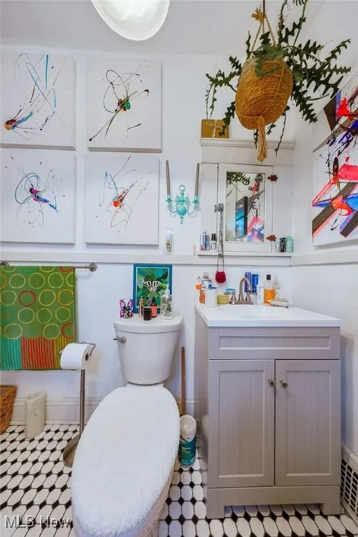 First floor unit bathroom featuring vanity and light flooring