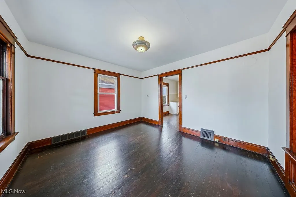 Second floor unit living room with baseboards and dark wood-type flooring