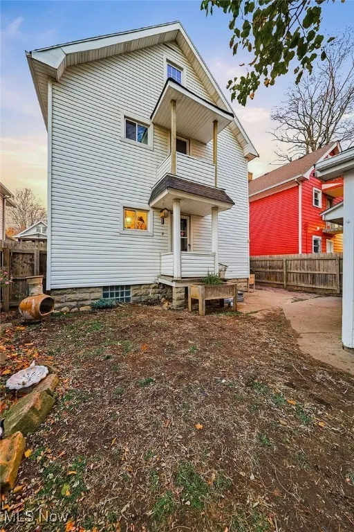View of back of house with a balcony