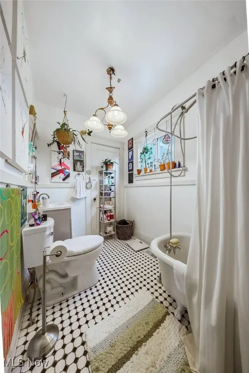 First floor unit bathroom with tile patterned floors, and a freestanding tub