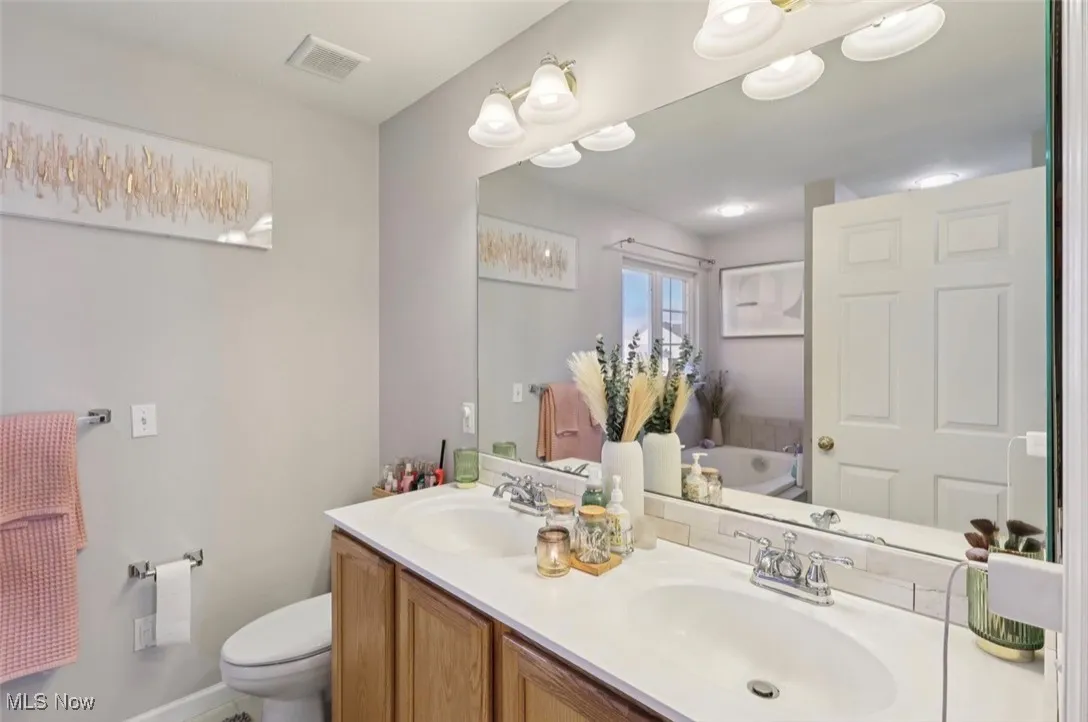 Bathroom with double vanity and a tub