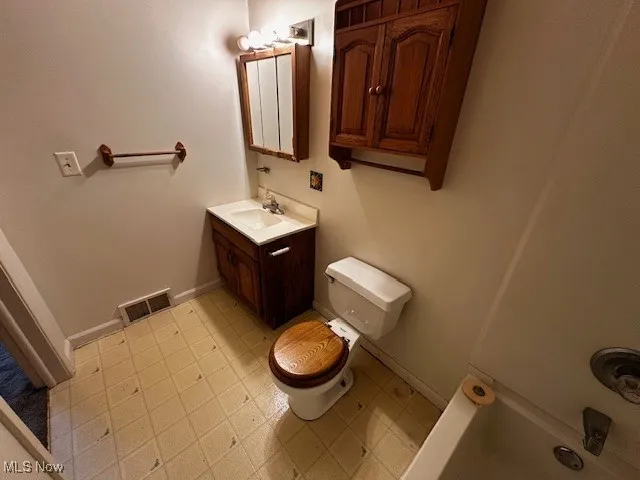 Bathroom with vanity and baseboards