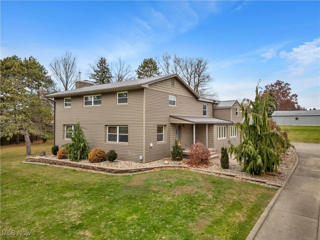 View of front of home with a front yard and a chimney