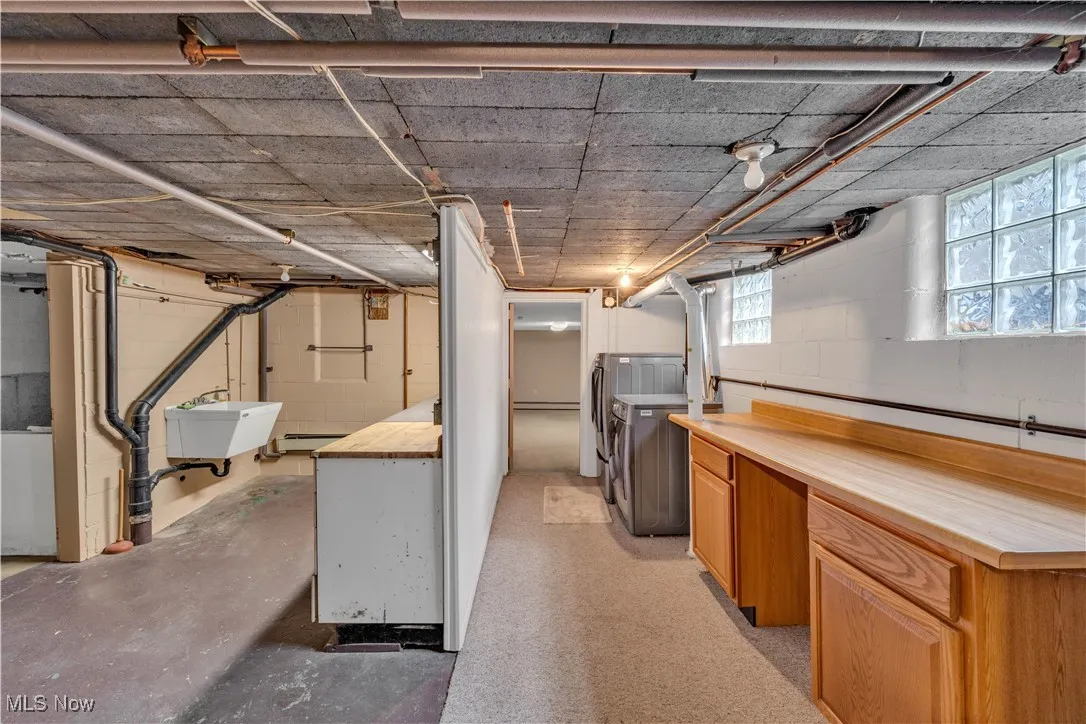 Basement featuring a sink and separate washer and dryer