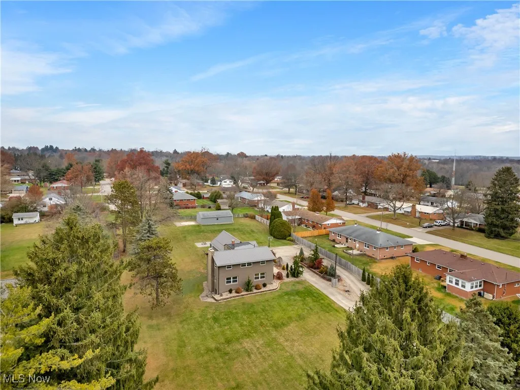 Aerial view of residential area featuring a tree filled landscape