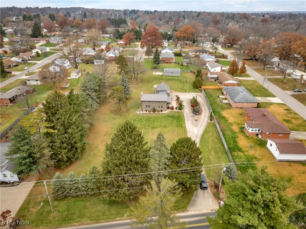 Aerial perspective of suburban area featuring a tree filled landscape
