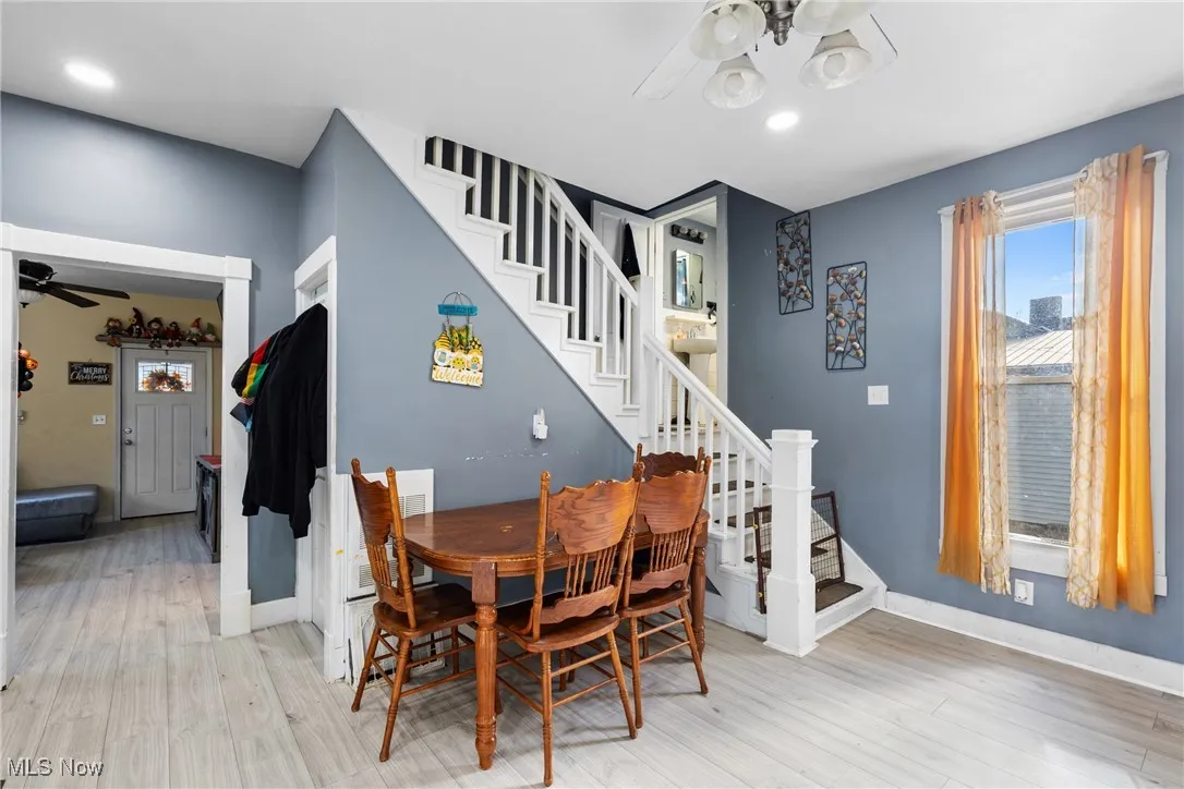 Dining room featuring a ceiling fan, light wood finished floors, stairs, and recessed lighting