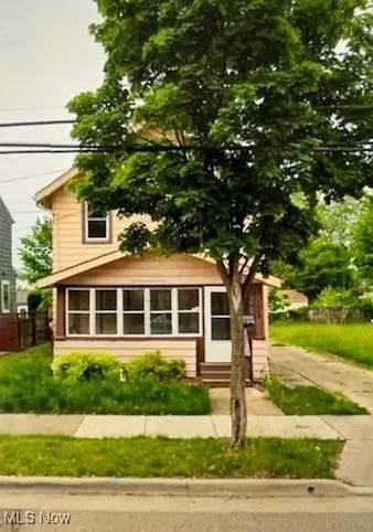 View of front of home featuring a sunroom and entry steps