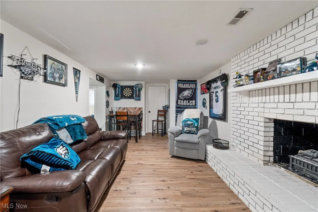 Living area featuring light wood finished floors and a fireplace