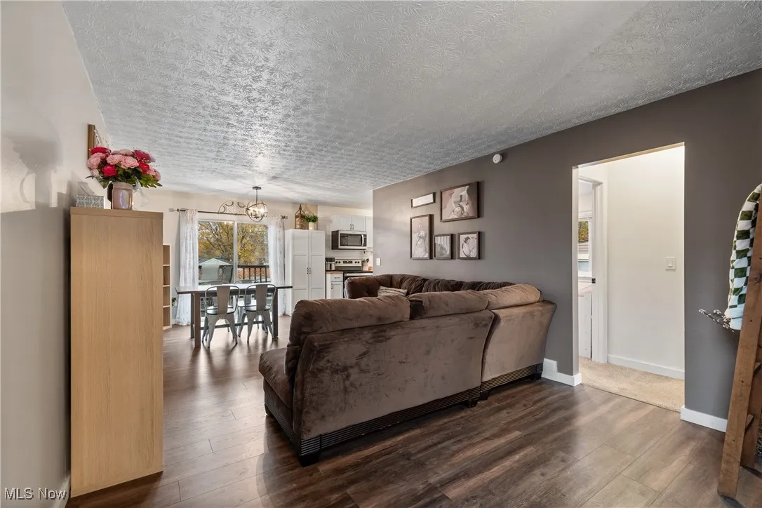 Living area with dark wood finished floors and a textured ceiling
