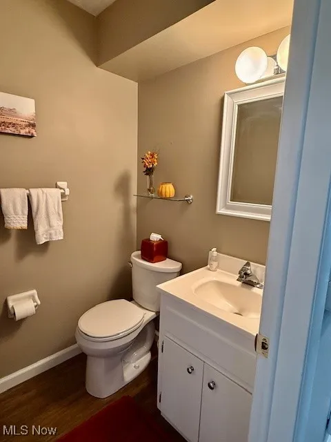 Bathroom featuring vanity and dark walnut LVP waterproof wood-type flooring