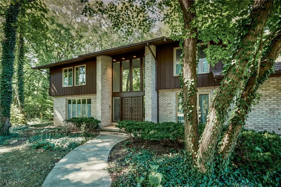 Entrance to property with brick and Cedar siding