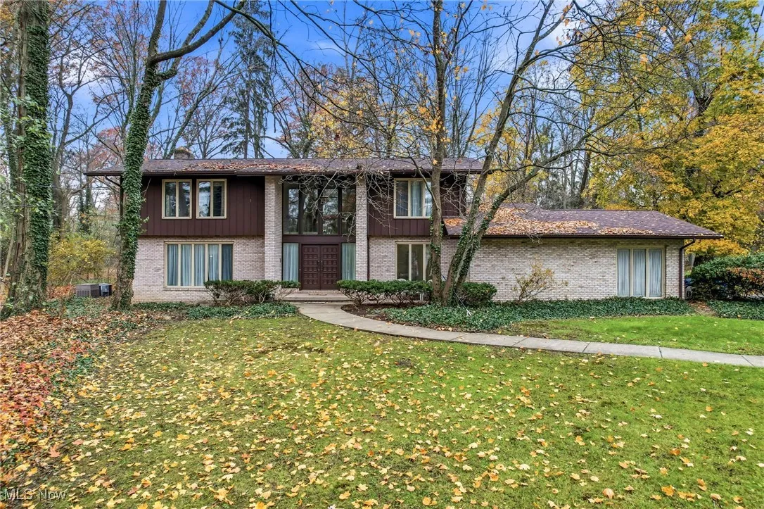 Modern home with brick, Cedar and a beautiful curved walkway to double front doors