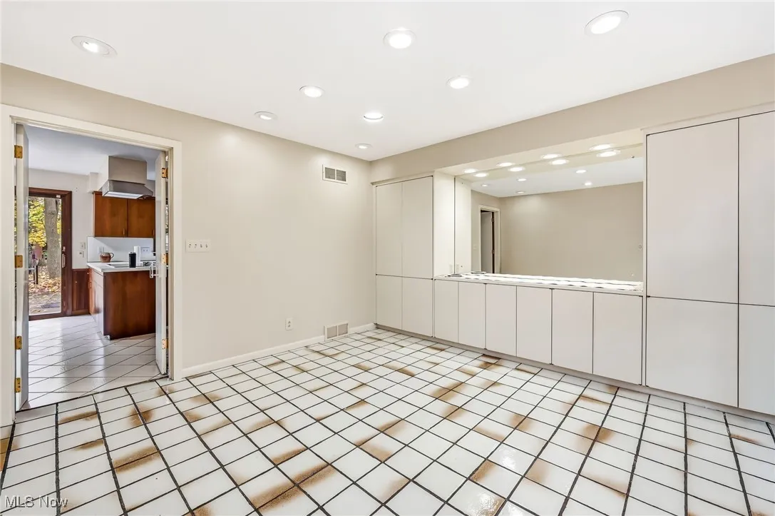 Dining Room with mirrors, built in’s and plenty of recessed lighting