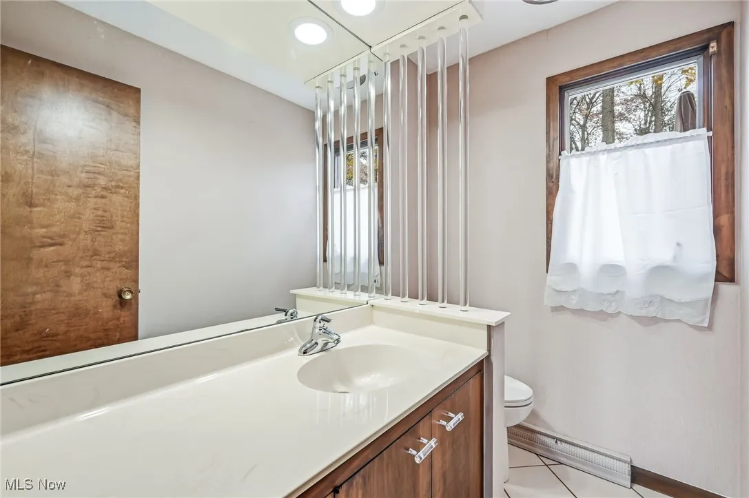 Bathroom with vanity, recessed lighting, and light tile patterned floors