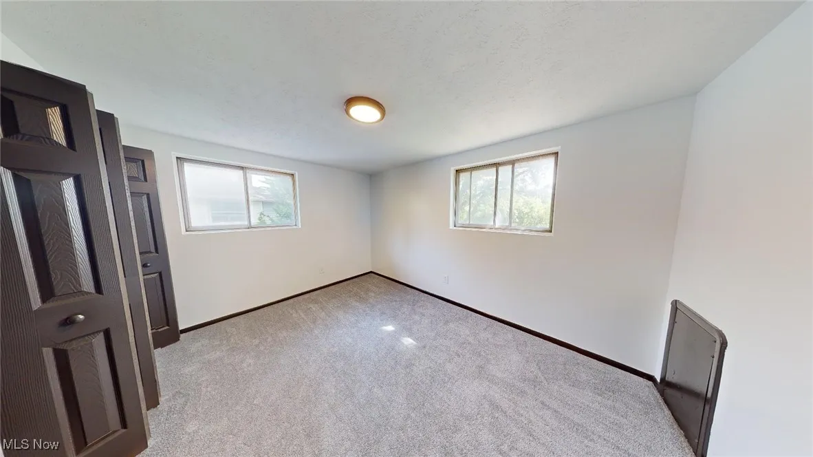 Unfurnished bedroom featuring carpet and a textured ceiling