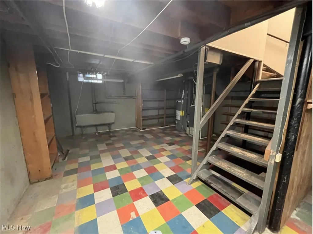 Basement with stairs and water heater