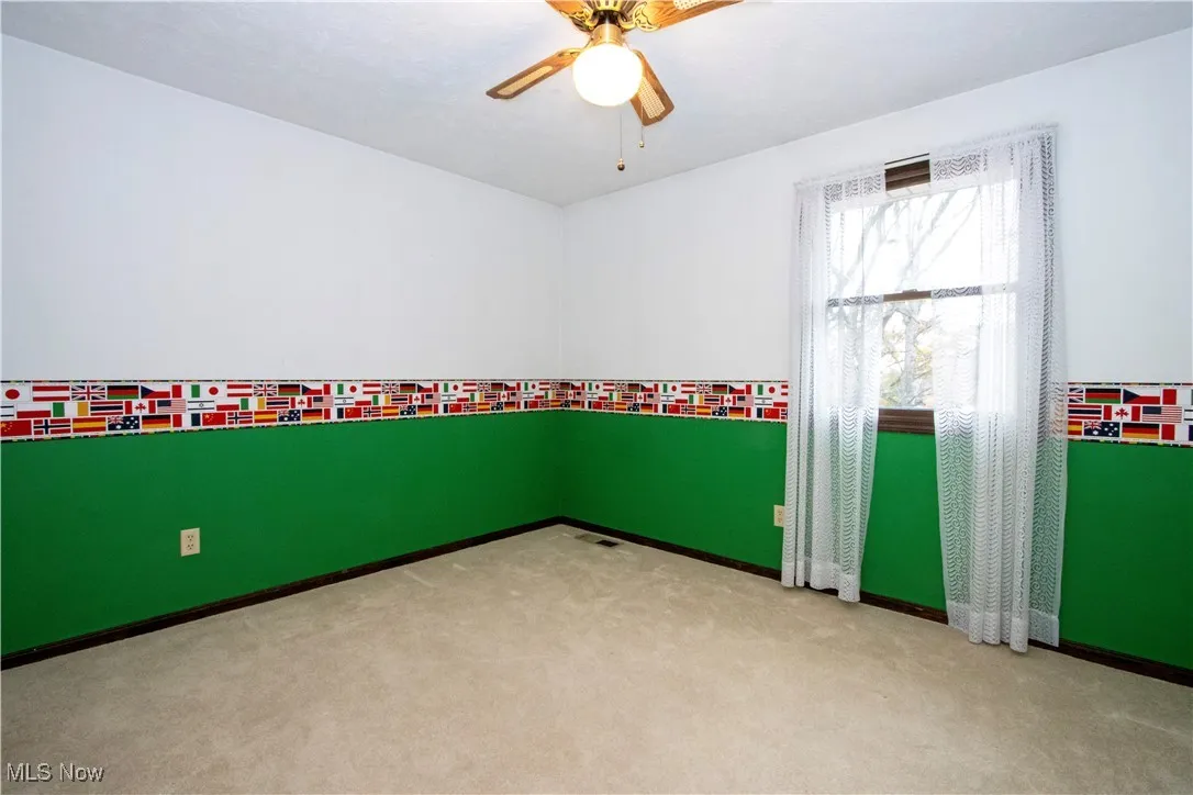 Unfurnished bedroom featuring carpet flooring, a closet, and a ceiling fan