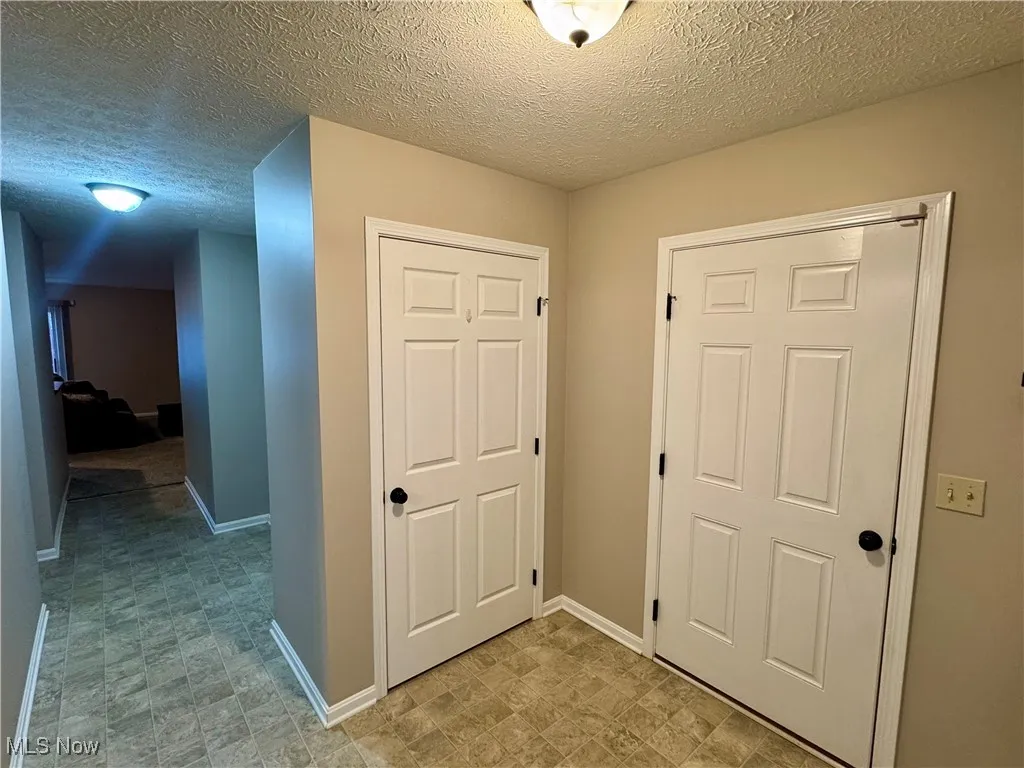 View from foyer of main hall, coat closet, and garage entrance