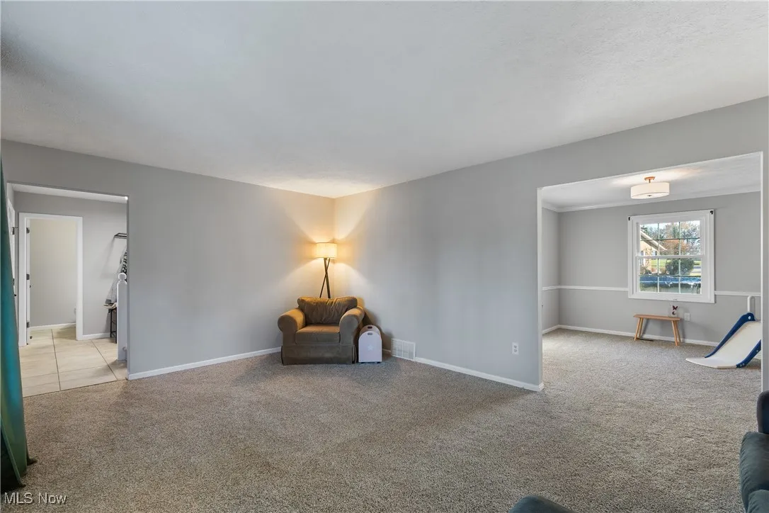 Unfurnished room with carpet floors and baseboards