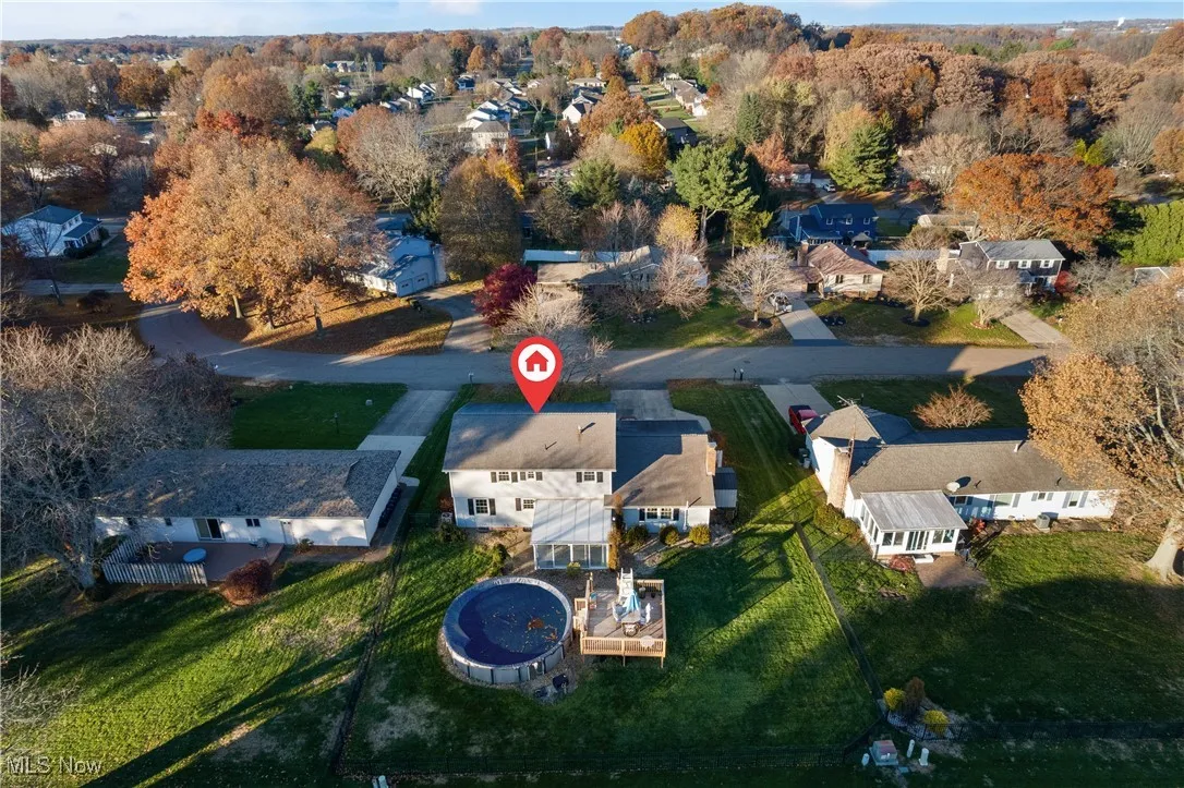Aerial view of property and surrounding area with nearby suburban area