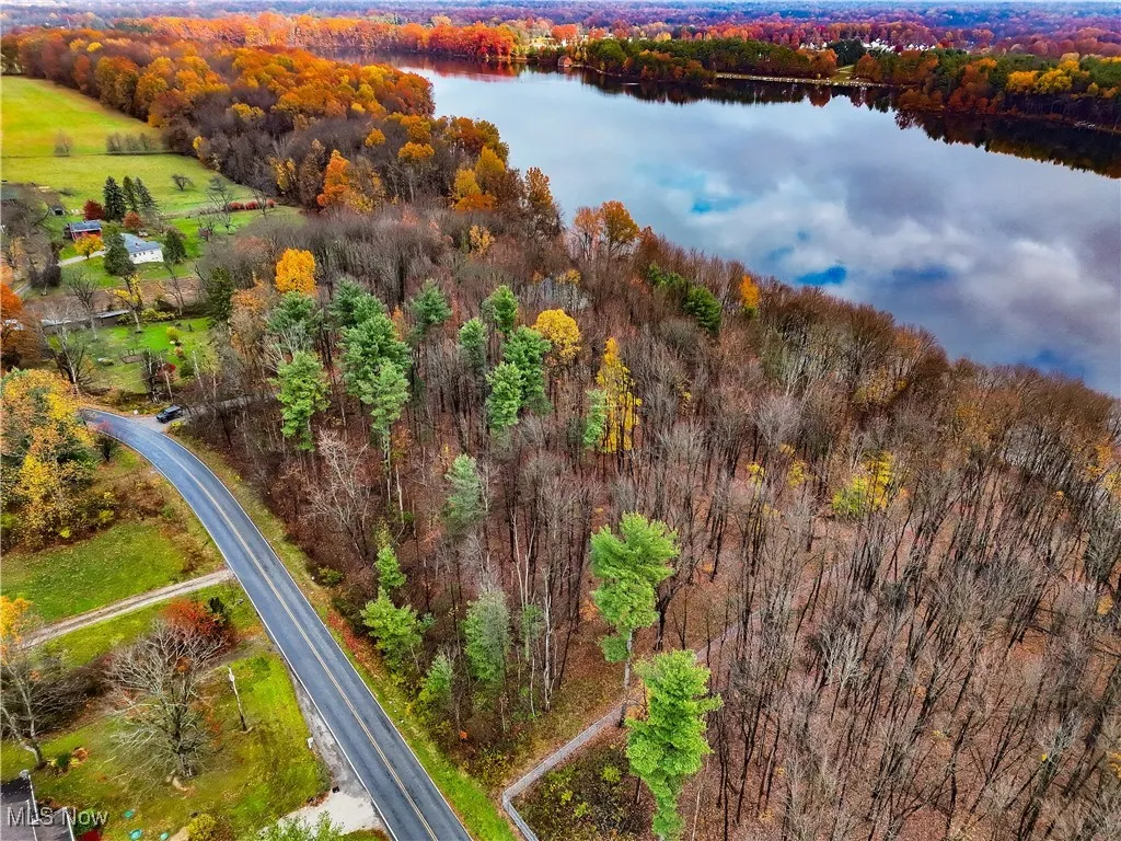 Aerial view of a heavily wooded area and a large body of water