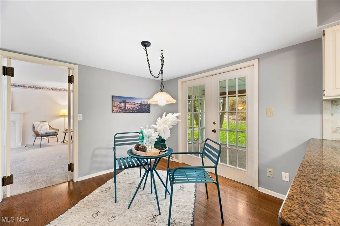 Dining space featuring french doors and dark wood finished floors