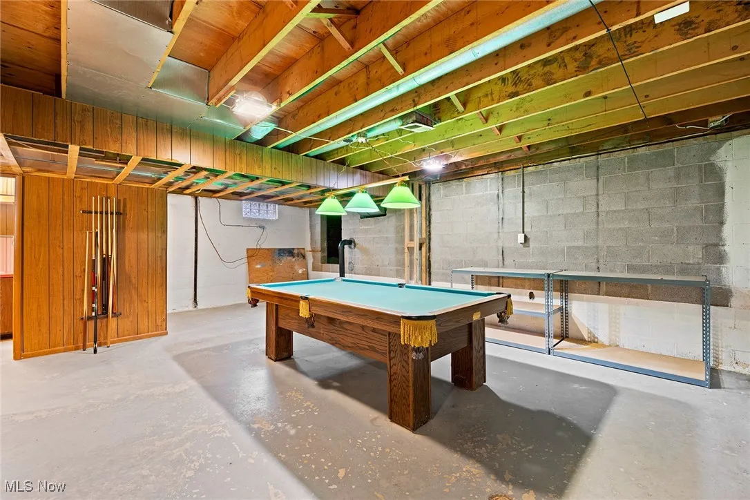 Recreation room featuring billiards and unfinished concrete flooring