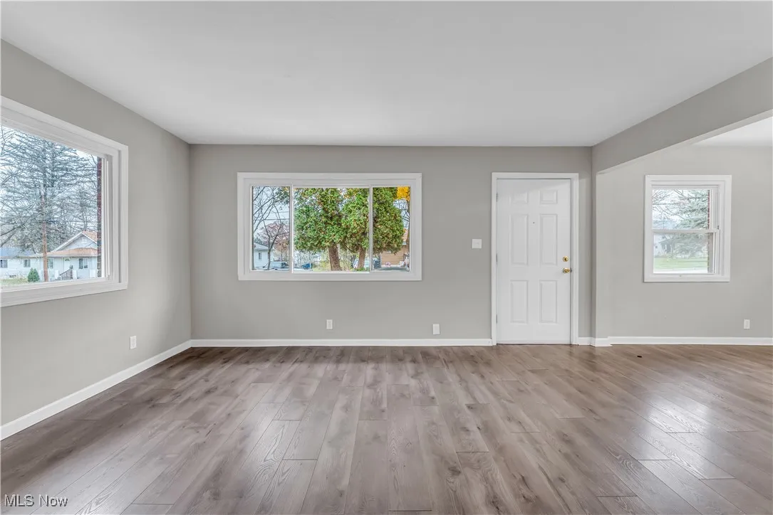 Unfurnished room with light wood-style flooring and healthy amount of natural light