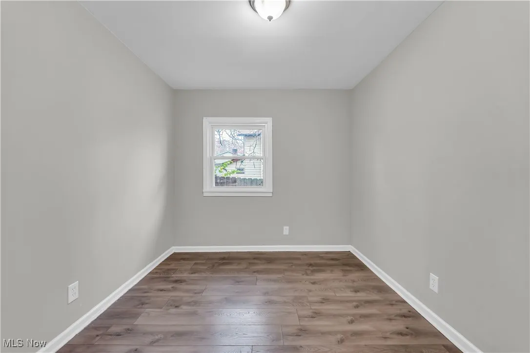 Empty room with light wood-type flooring and baseboards