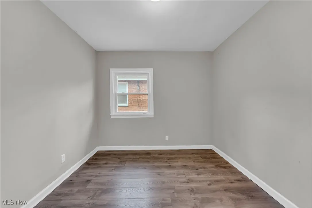 Spare room with wood finished floors and baseboards