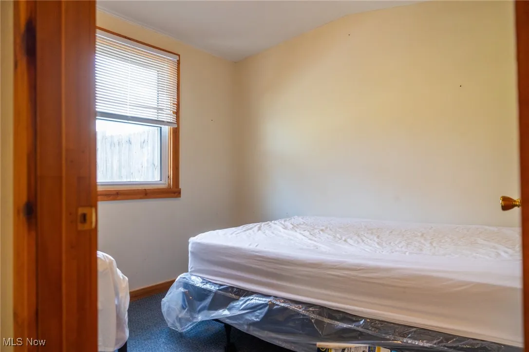 Bedroom featuring vaulted ceiling and baseboards