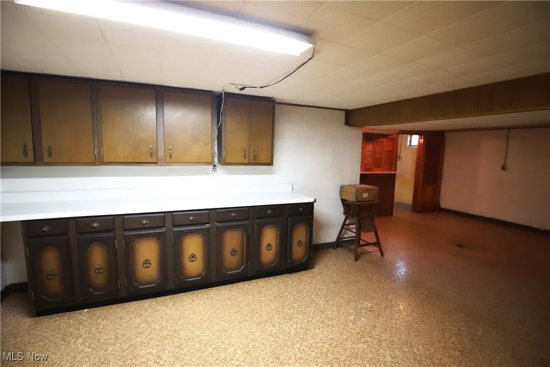 Finished basement featuring light floors