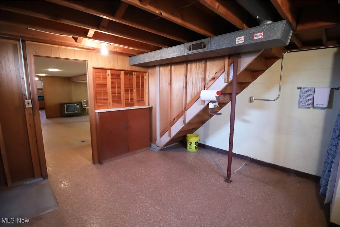 Below grade area with wooden walls and stairs