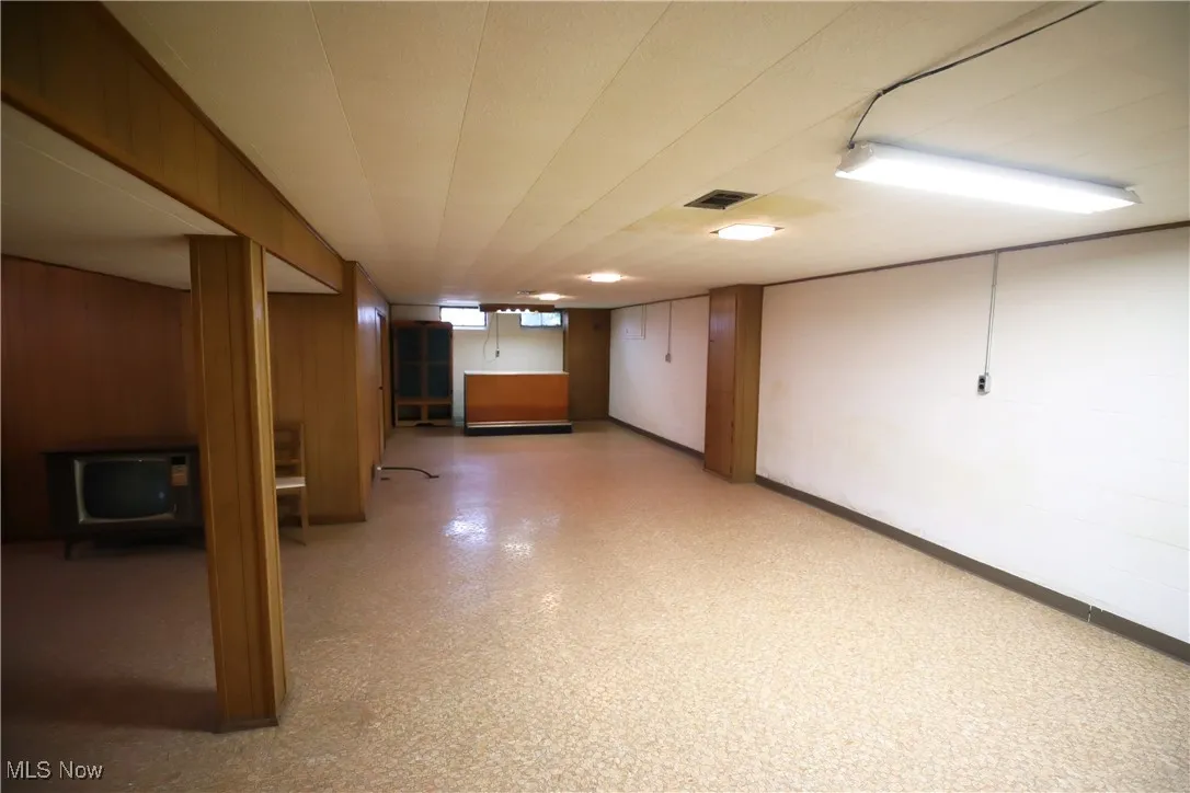 Basement featuring light floors