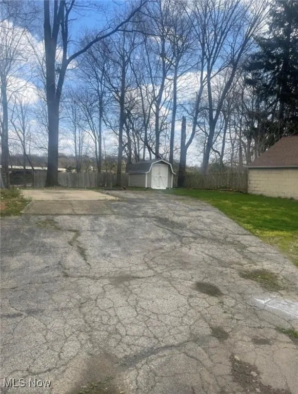 View of patio featuring a storage unit