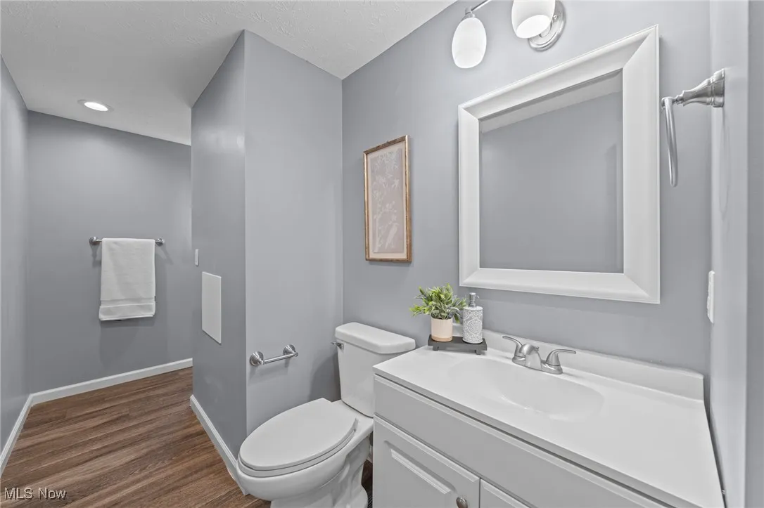 Bathroom with vanity, recessed lighting, and dark wood-type flooring
