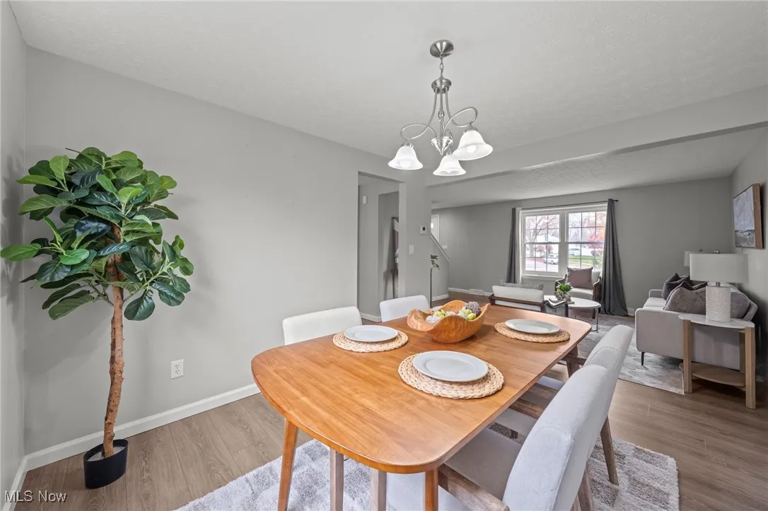 Dining area featuring light wood-style floors and a chandelier