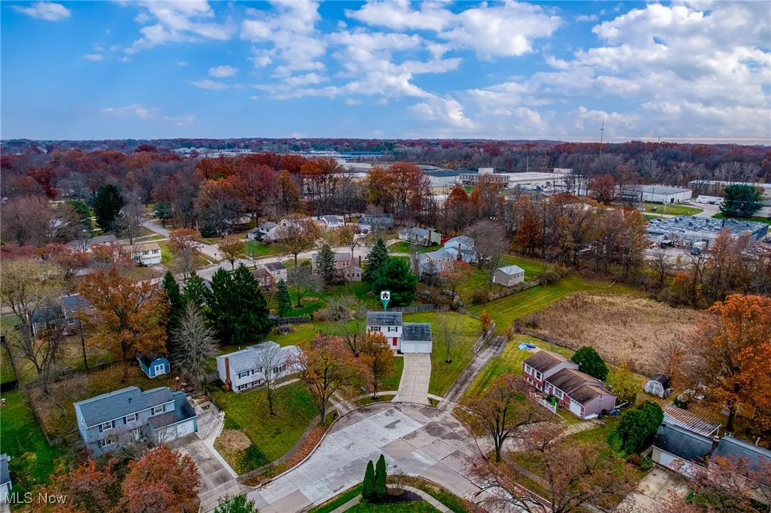Aerial view of property's location with nearby suburban area