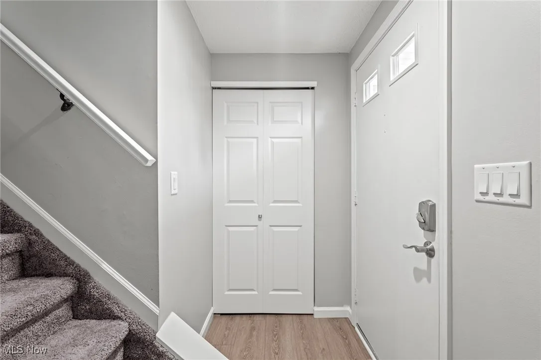Foyer featuring stairway and light wood-style floors