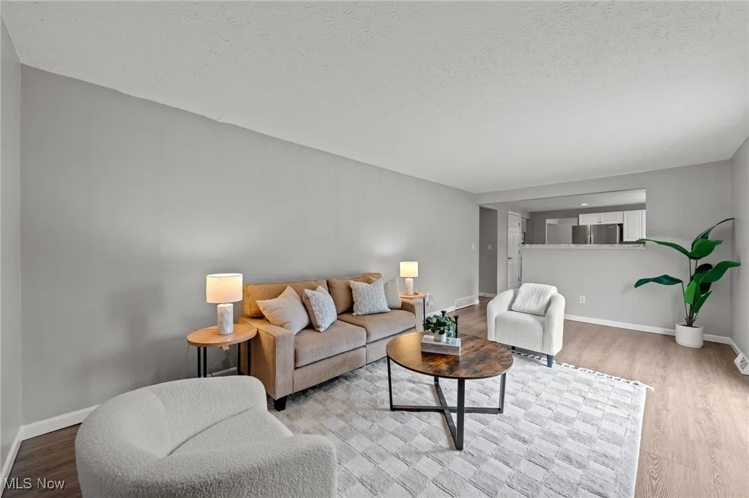 Living area featuring wood finished floors and a textured ceiling