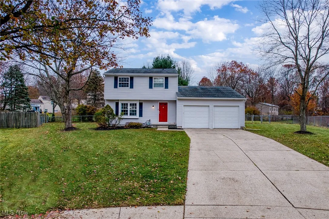 Colonial house with an attached garage and concrete driveway