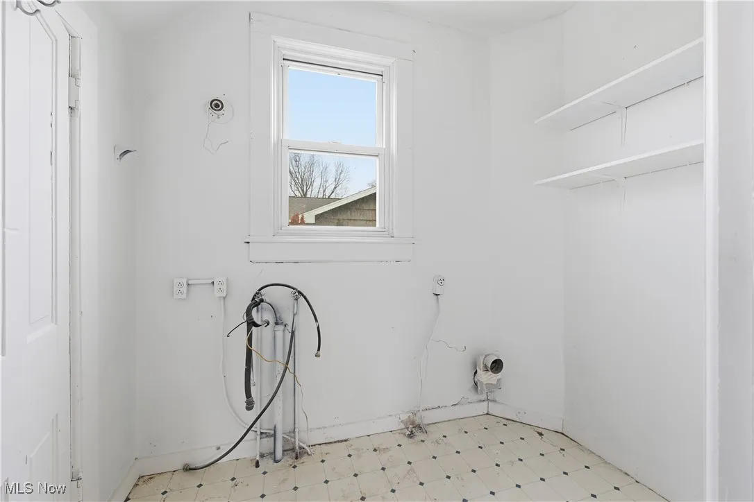 Washroom featuring light floors and baseboards