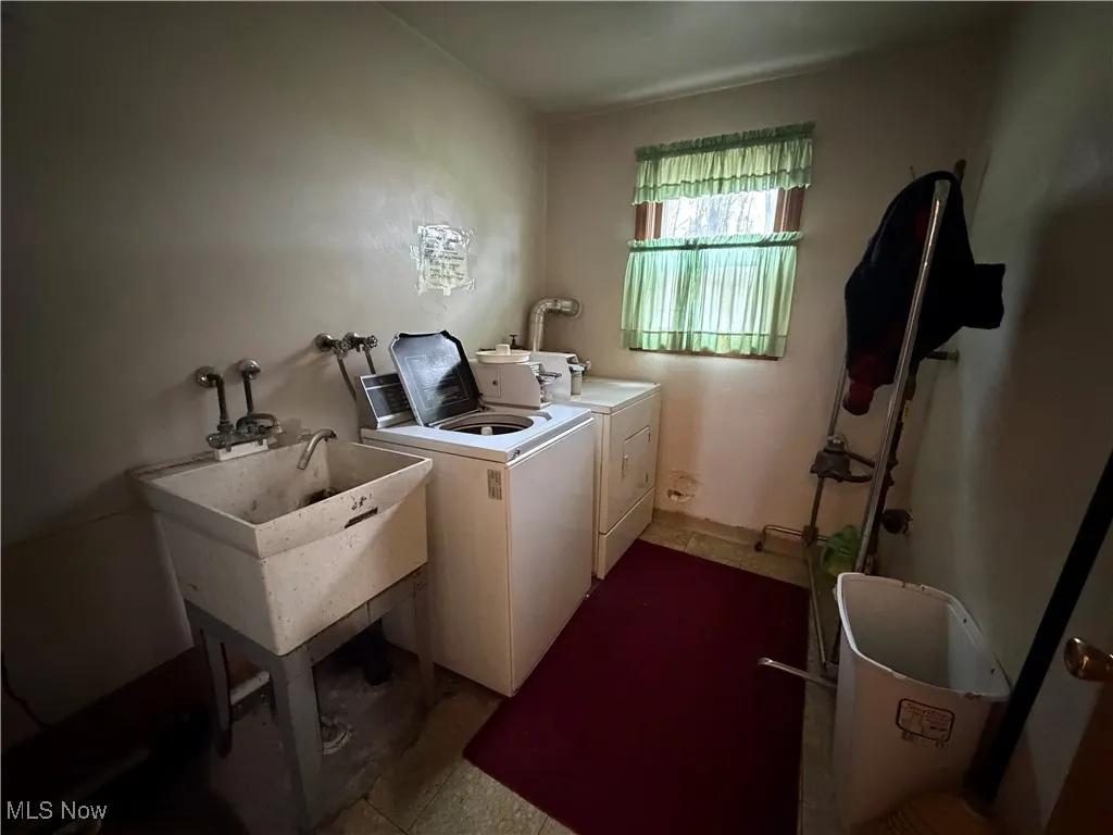 Laundry room with a sink and washer and clothes dryer