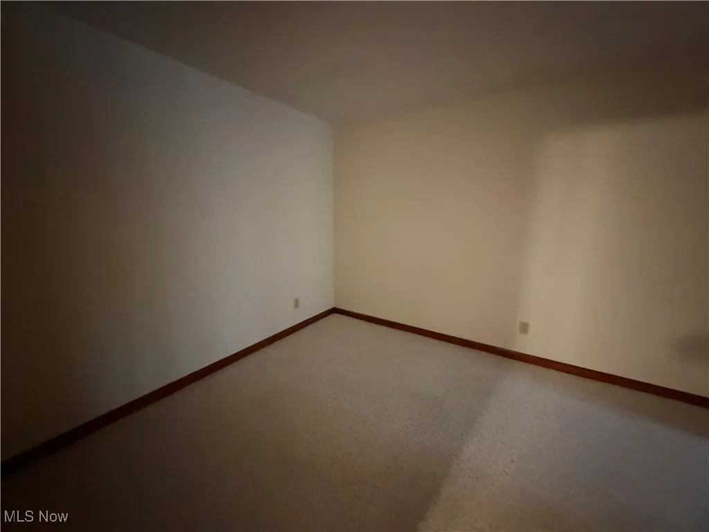 Spare room featuring baseboards