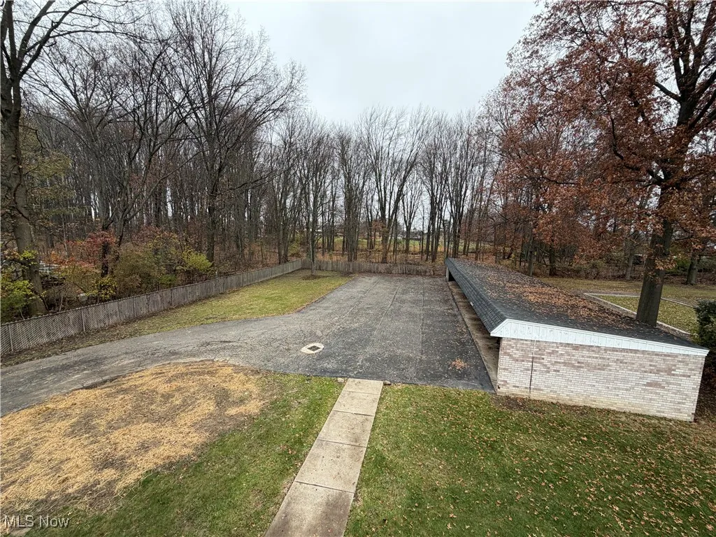 View of road with view of wooded area