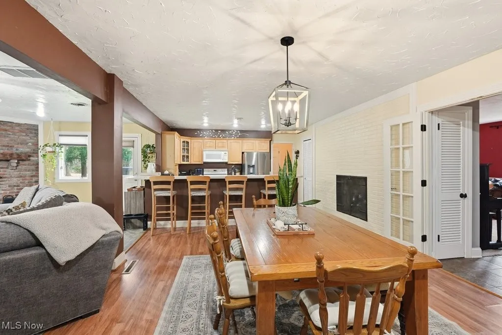Dining Room with Fireplace and View of Eat-in Kitchen